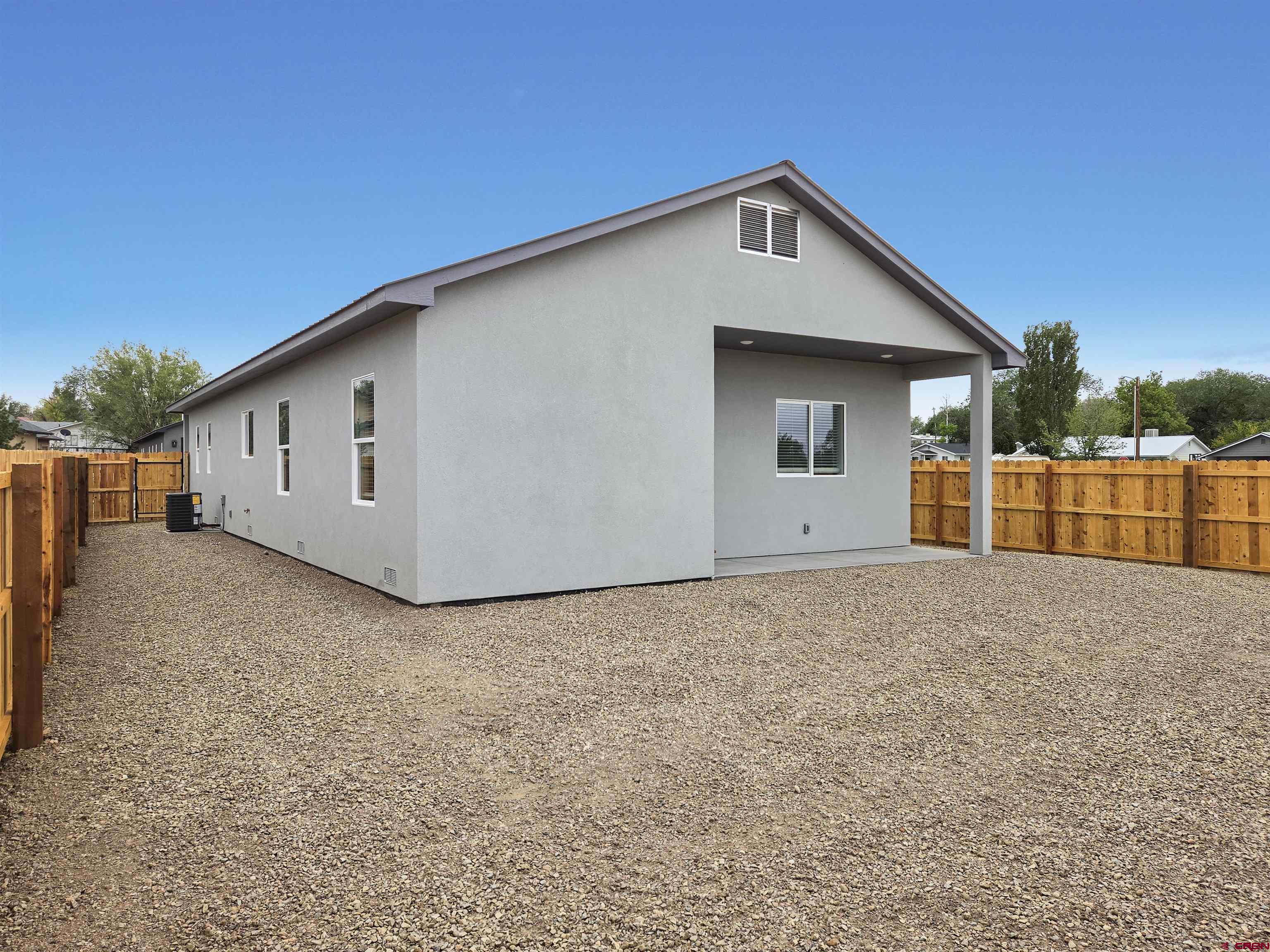 1456 Acoma Street Cortez, CO 81321 - Photo 24 of 26 a front view of a house with a yard