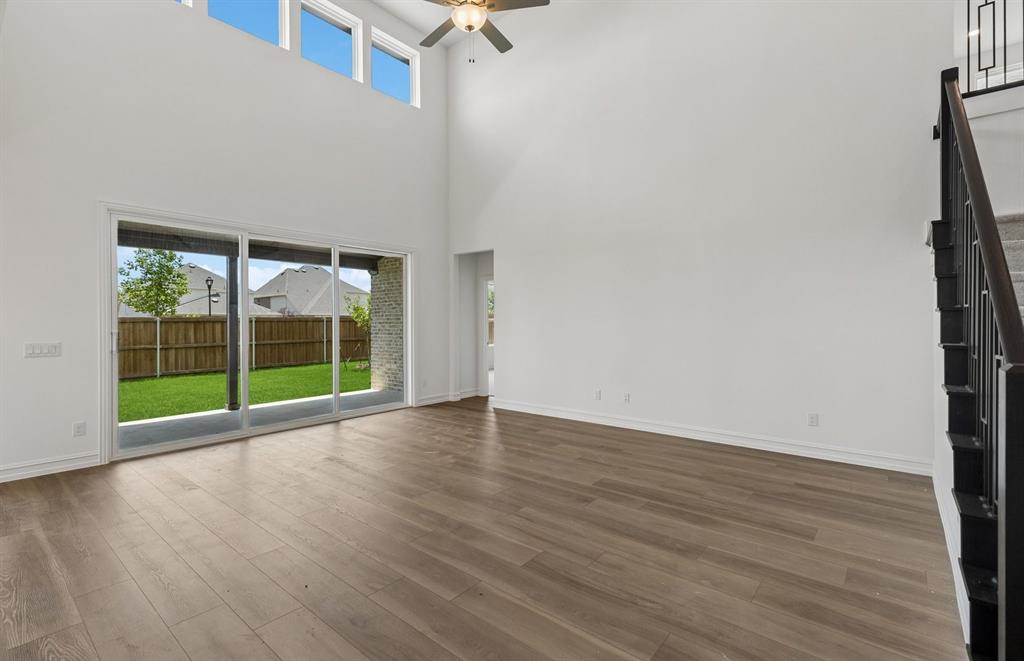 11220 Abbotsbury Road Fort Worth, TX 76052 - Photo 7 of 32 a view of an empty room with wooden floor and a window