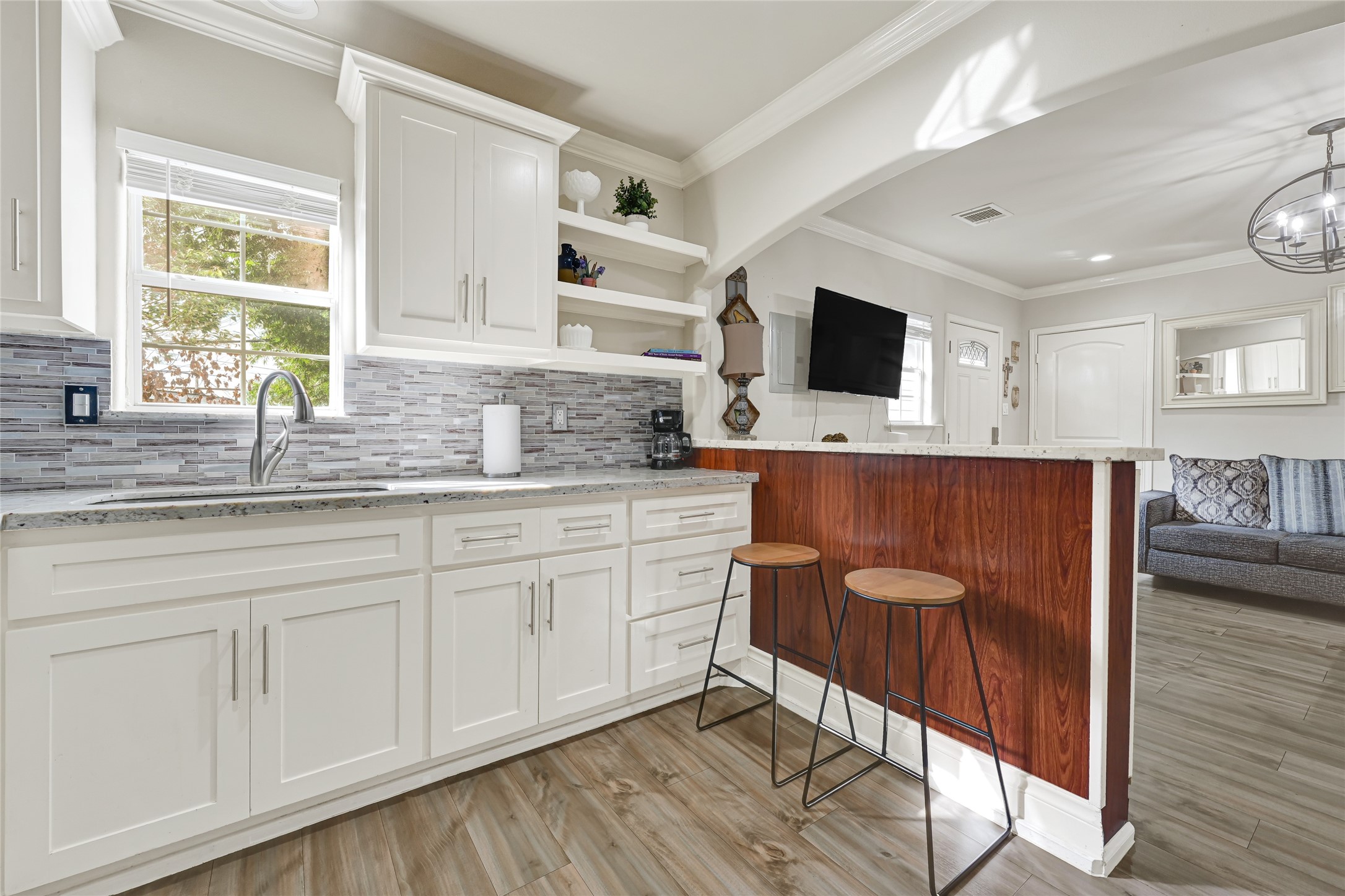 2809 Tooke Street Houston, TX 77023 - Photo 29 of 50 a kitchen with stainless steel appliances granite countertop a sink and cabinets with wooden floor