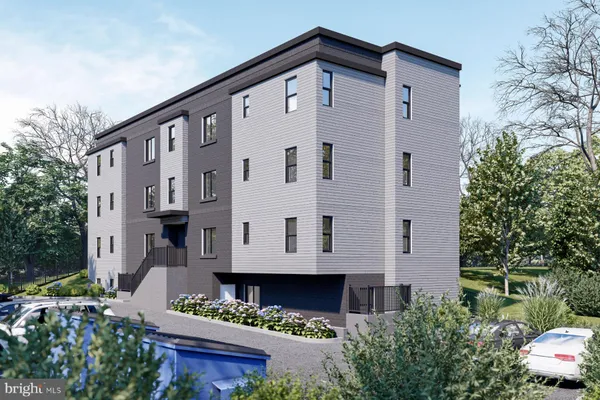 a front view of a house with plants and trees