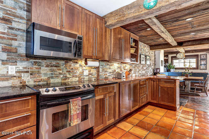 16 Apache Place Riverside, CT 06878 - Photo 6 of 27 a kitchen with stainless steel appliances granite countertop wooden cabinets stove top oven and sink