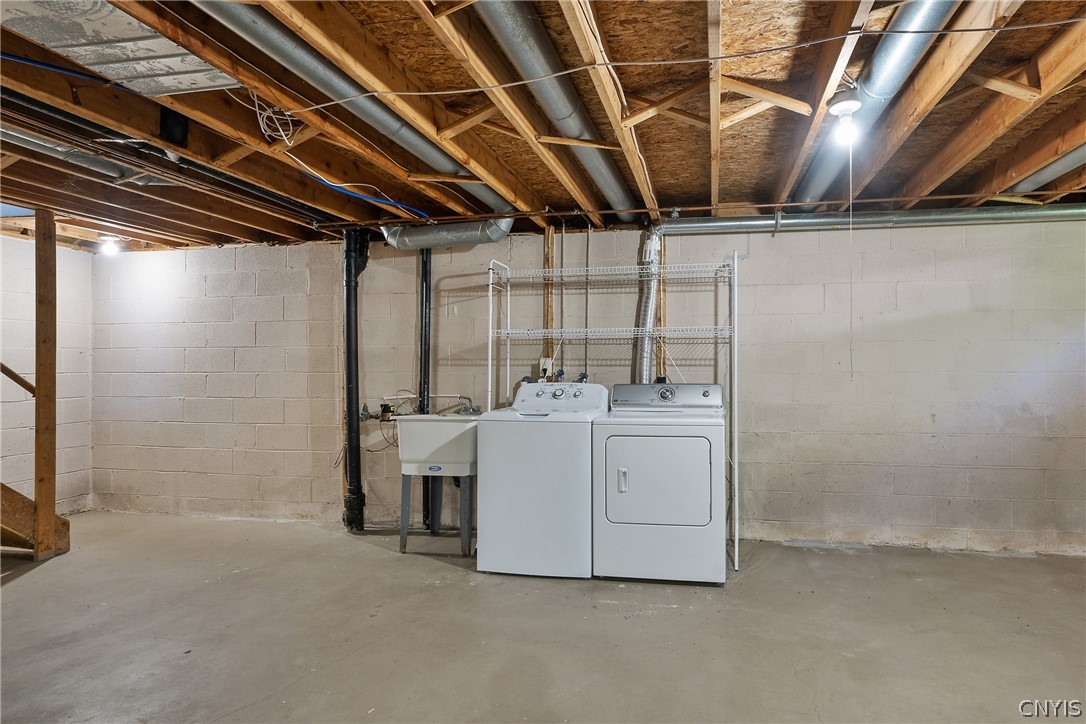 8841 Wandering Way Lysander, NY 13027 - Photo 33 of 42 Washer, dryer & utility sink in basement.