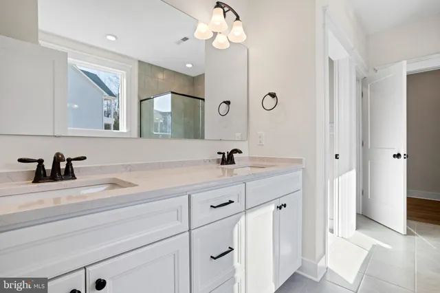 a bathroom with a sink a light fixture and a mirror