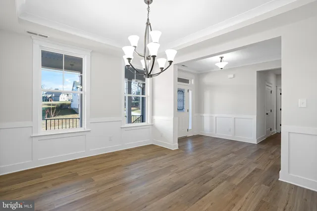 a view of a house with wooden floor and a chandelier