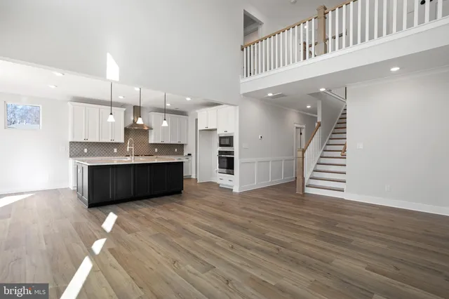 a kitchen with stainless steel appliances kitchen island a cabinets and wooden floor