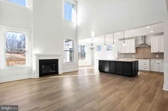 a large white kitchen with a large window and cabinets