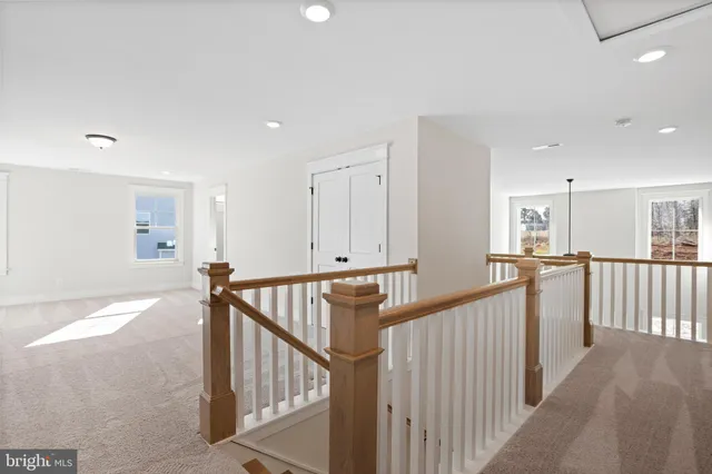 a view of a hallway with workspace and stairs