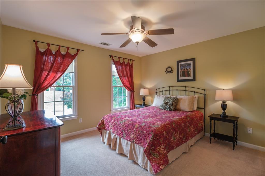 4330 Farmbrook Lane Cumming, GA 30041 - Photo 33 of 46 a bedroom with a bed and a chandelier