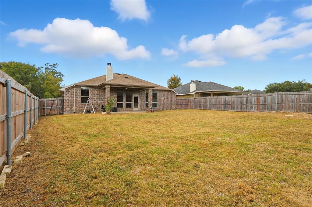 2512 Guinn Farms Road Tyler, TX 75707 - Photo 13 of 29 a front view of a house with a garden