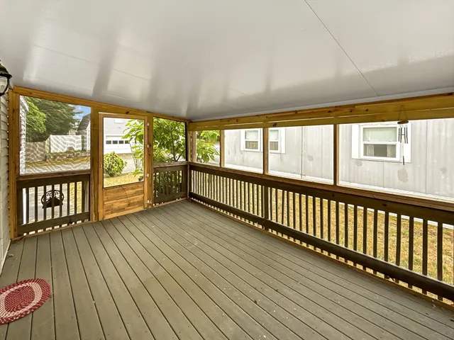 a view of a room with wooden floor and large windows