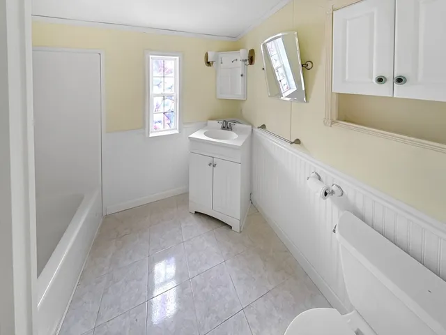 a room with a white cabinets and sink