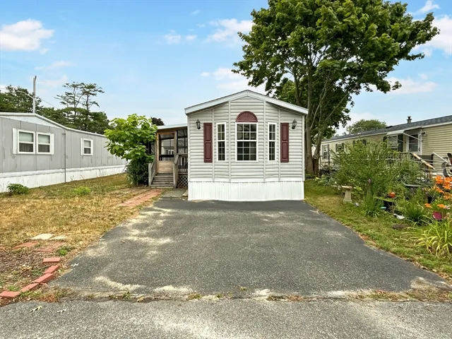 a front view of a house with a yard garage and outdoor seating