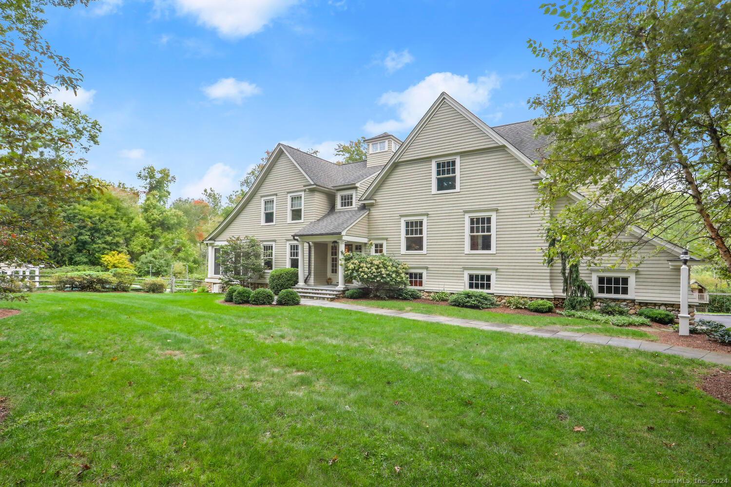 a front view of house with yard and green space