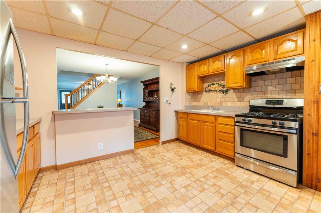 2222 Stuart Street Brooklyn, NY 11229 - Photo 12 of 31 a kitchen with stainless steel appliances granite countertop a stove a sink and a refrigerator