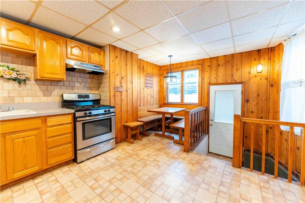 2222 Stuart Street Brooklyn, NY 11229 - Photo 14 of 31 a kitchen with granite countertop a stove a sink and a refrigerator