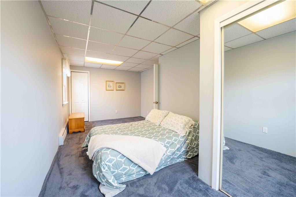 2222 Stuart Street Brooklyn, NY 11229 - Photo 19 of 31 a spacious bedroom with a bed and wooden floor