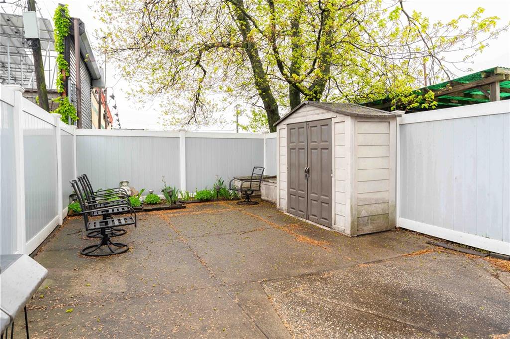 2222 Stuart Street Brooklyn, NY 11229 - Photo 30 of 31 a backyard of a house with plants and trees