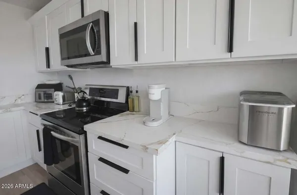 a kitchen with appliances a sink and cabinets