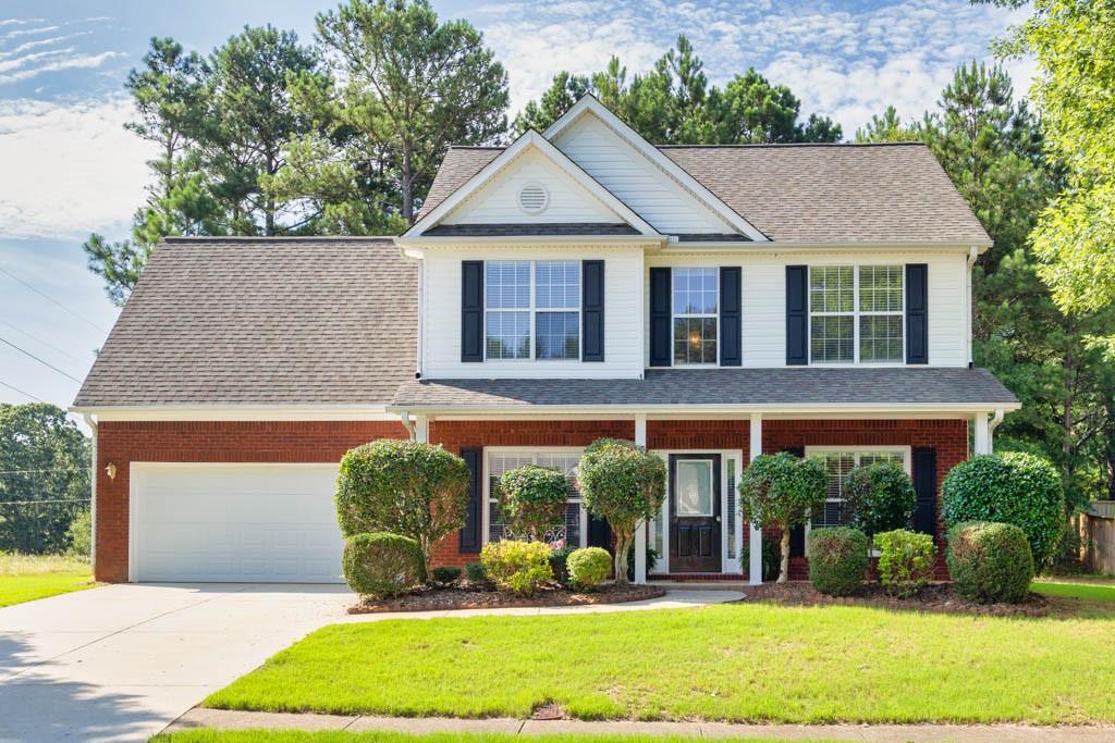 a front view of a house with garden