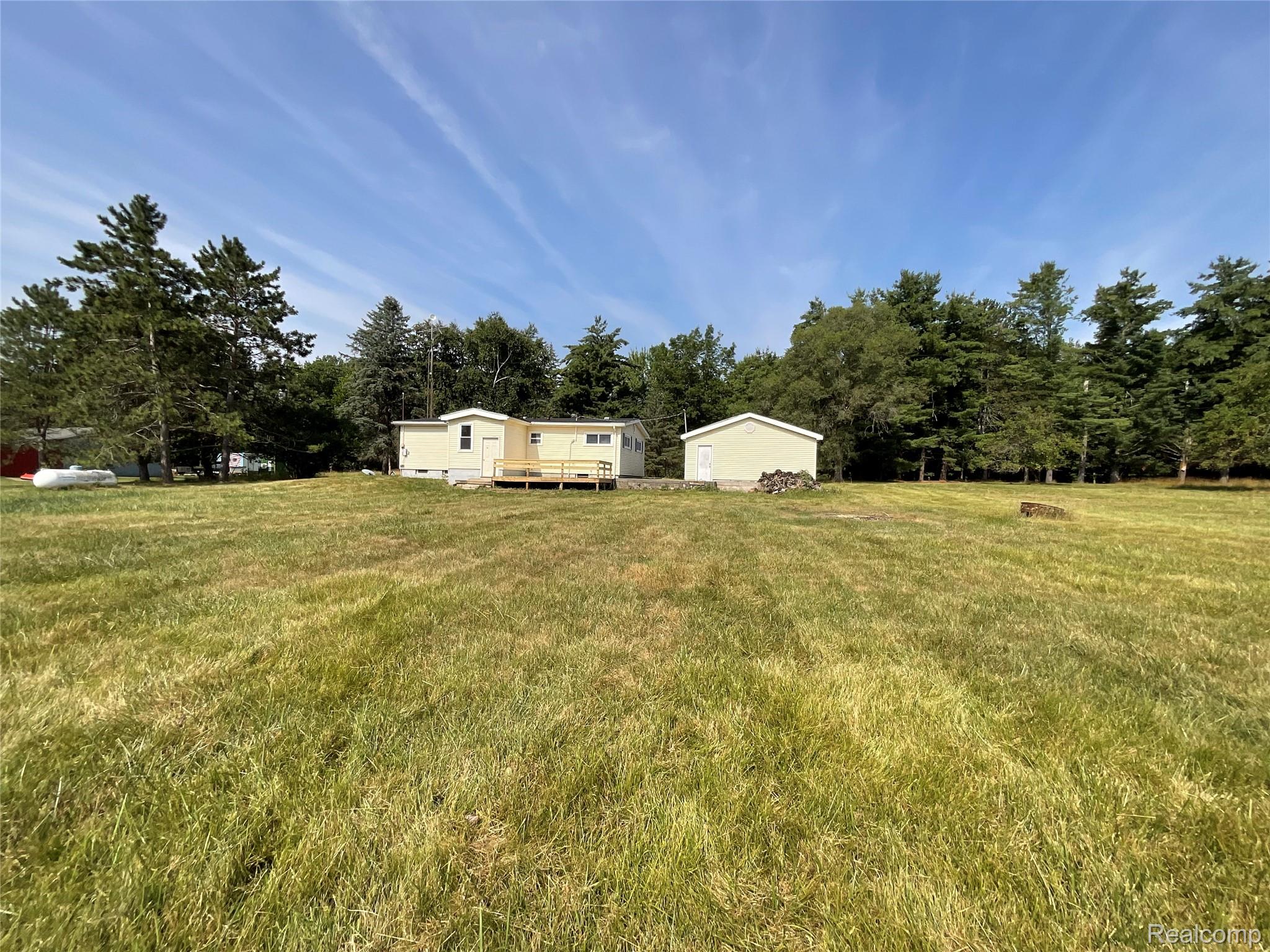 10119 Godfrey Road Bancroft, MI 48414 - Photo 34 of 47 Expansive grassy area with a detached structure