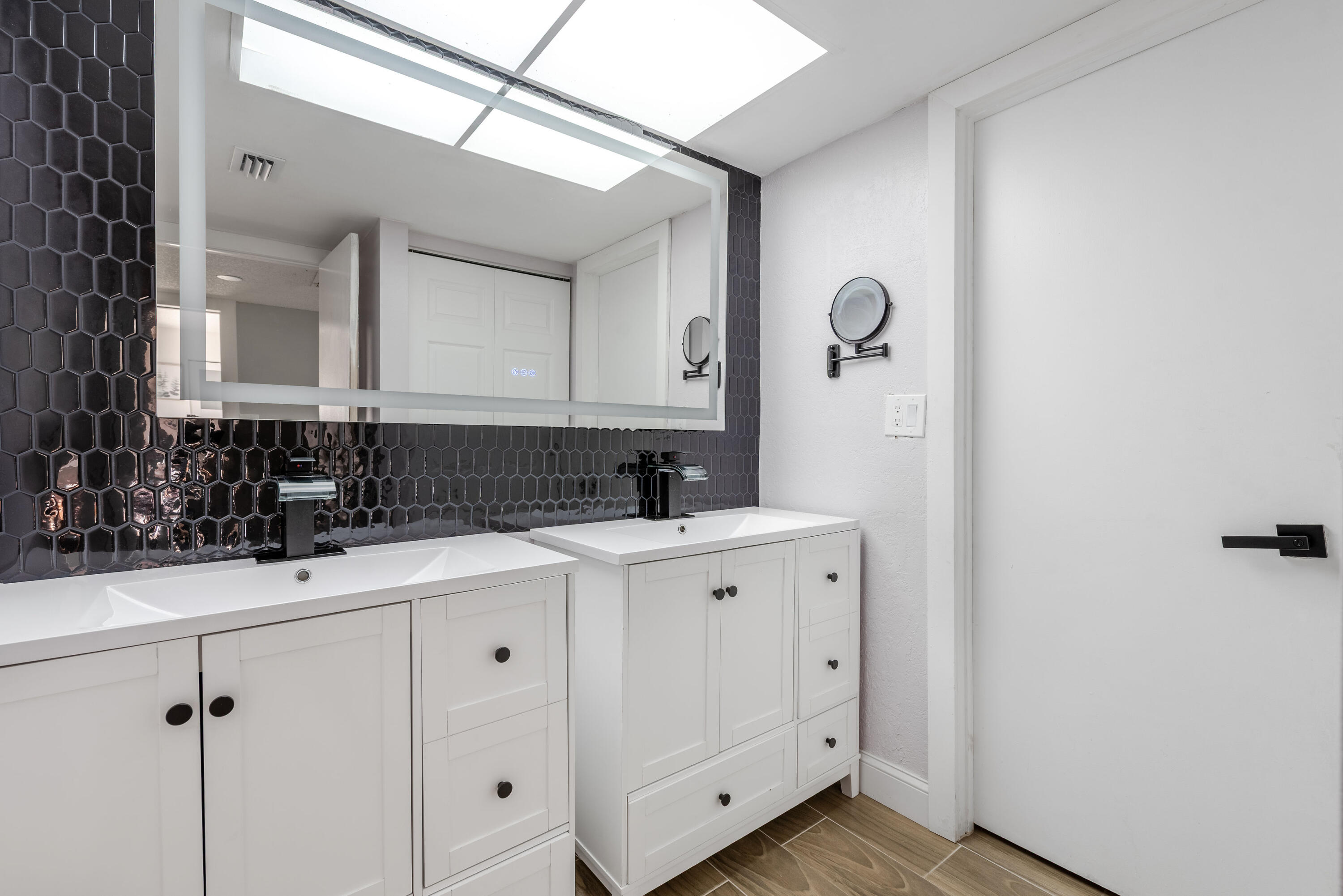 4572 Cherry Road West Palm Beach, FL 33417 - Photo 12 of 27 a view of a sink a mirror and cabinets