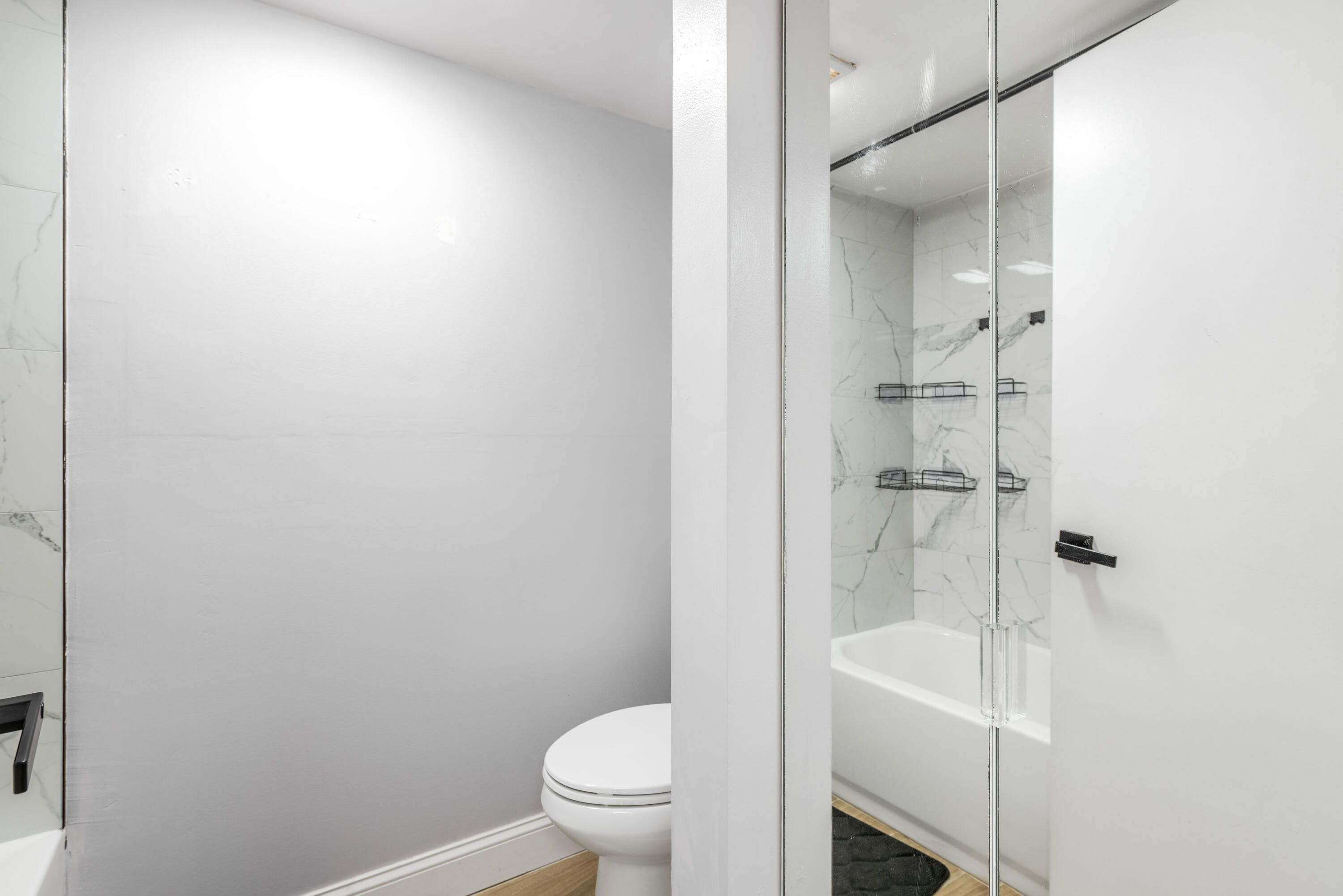 4572 Cherry Road West Palm Beach, FL 33417 - Photo 15 of 27 a white toilet sitting next to a bathroom sink