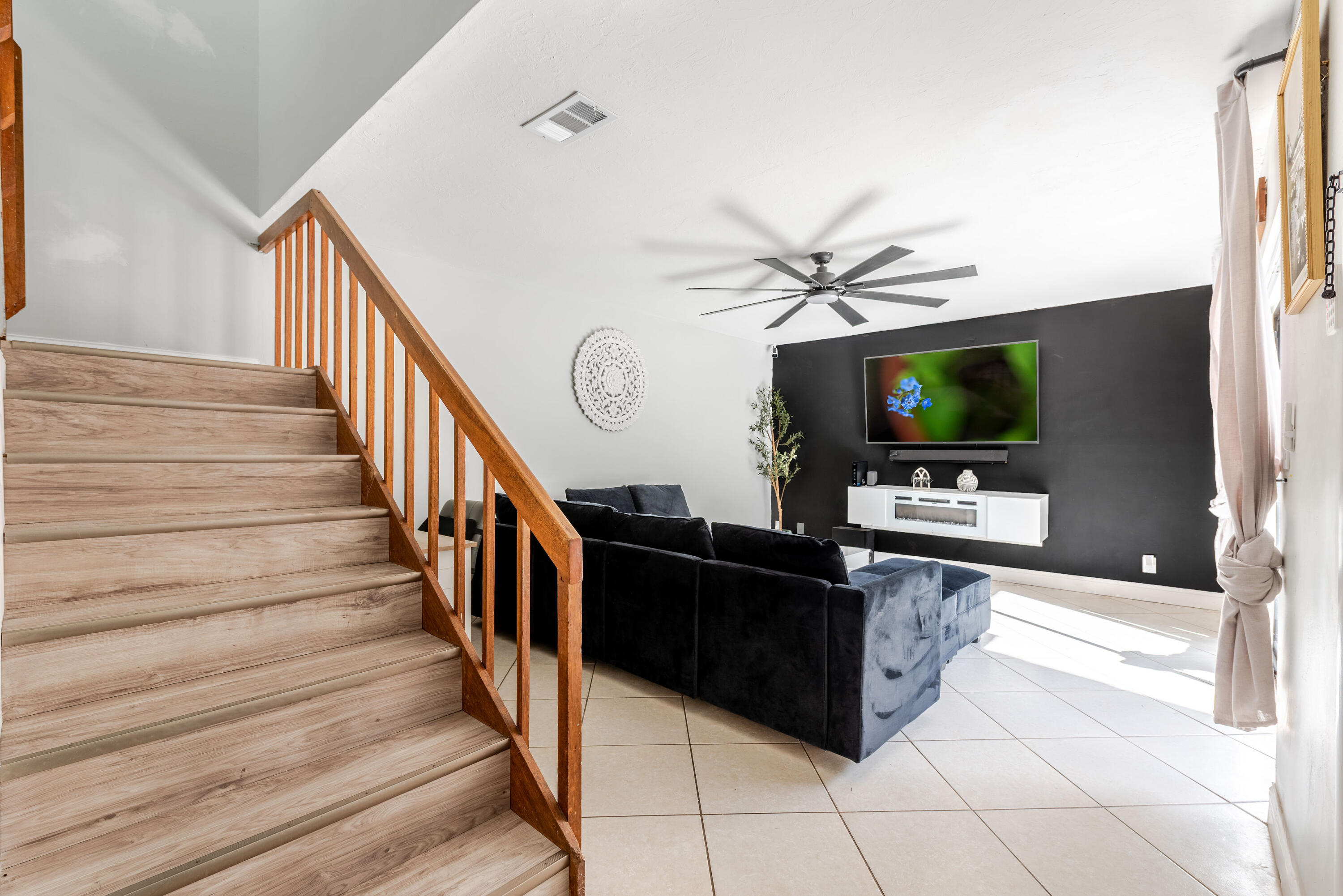 4572 Cherry Road West Palm Beach, FL 33417 - Photo 4 of 27 a living room with wooden floor and a flat screen tv