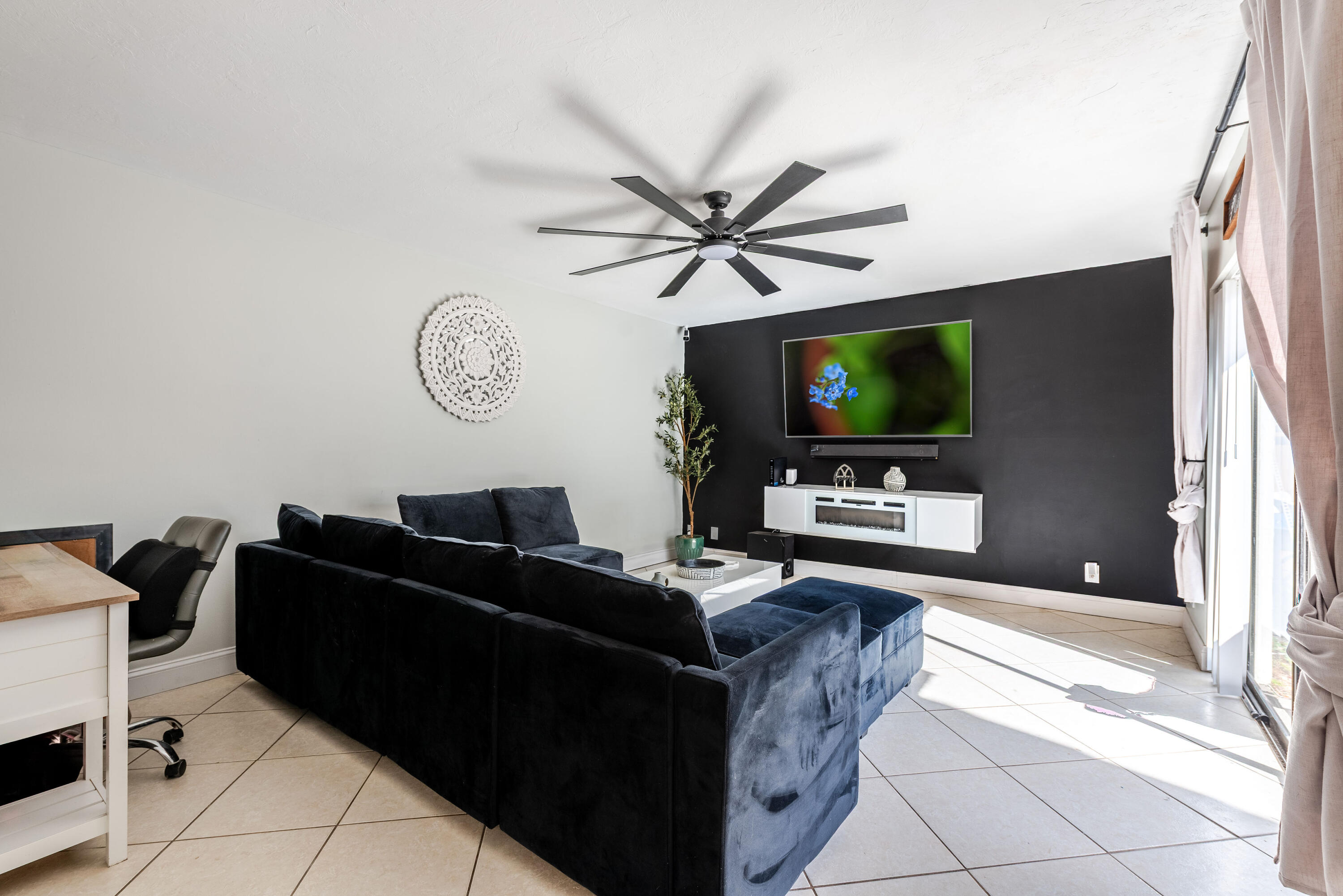 4572 Cherry Road West Palm Beach, FL 33417 - Photo 5 of 27 a living room with furniture a flat screen tv and a window