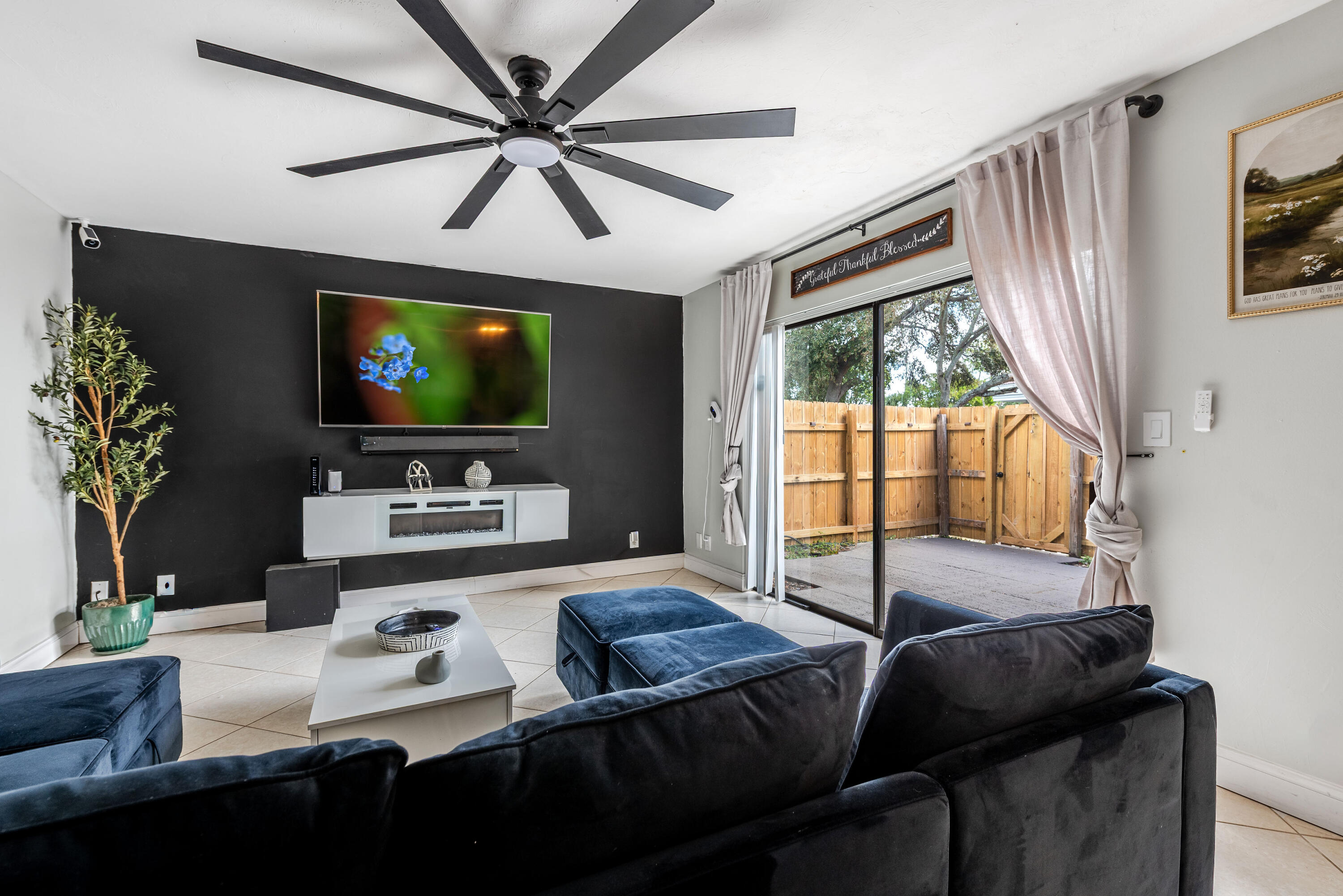 4572 Cherry Road West Palm Beach, FL 33417 - Photo 6 of 27 a living room with furniture a flat screen tv and a large window