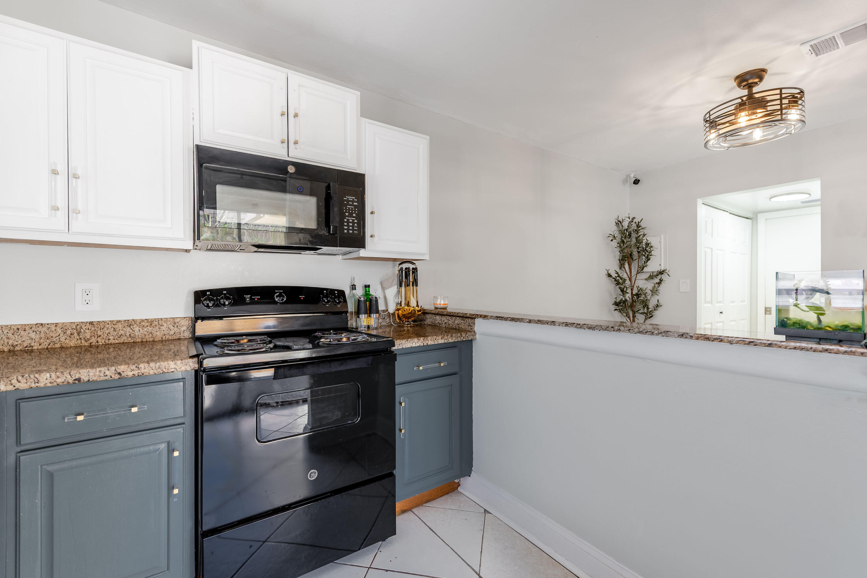 4572 Cherry Road West Palm Beach, FL 33417 - Photo 8 of 27 a kitchen with stainless steel appliances white cabinets and a stove top oven