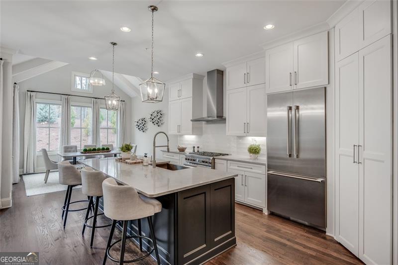3450 Commander Suwanee, GA 30024 - Photo 17 of 52 a kitchen with kitchen island granite countertop a sink cabinets and stainless steel appliances