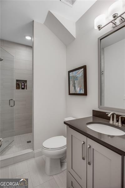 3450 Commander Suwanee, GA 30024 - Photo 36 of 52 a bathroom with a granite countertop toilet sink and shower