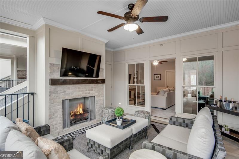 3450 Commander Suwanee, GA 30024 - Photo 38 of 52 a living room with furniture a flat screen tv and a fireplace