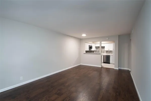 a view of a kitchen with a sink and wooden floor