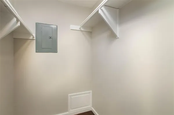 a view of walk in closet with empty racks