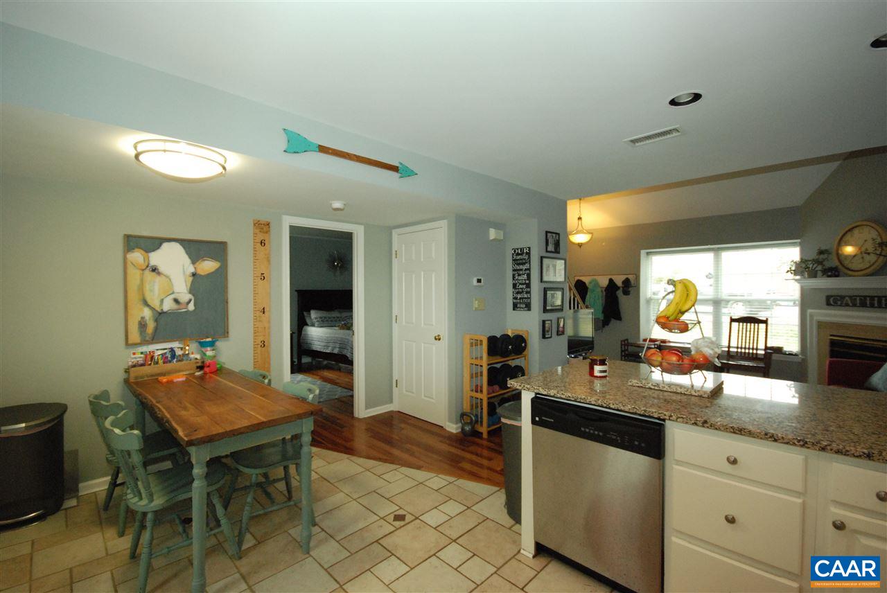 987 Amber Ridge Road Charlottesville, VA 22901 - Photo 6 of 19 a kitchen with stainless steel appliances granite countertop a table and chairs in it