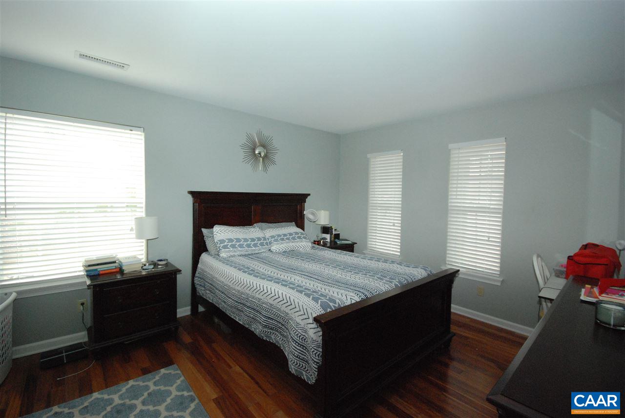 987 Amber Ridge Road Charlottesville, VA 22901 - Photo 9 of 19 a bedroom with a bed and wooden floor