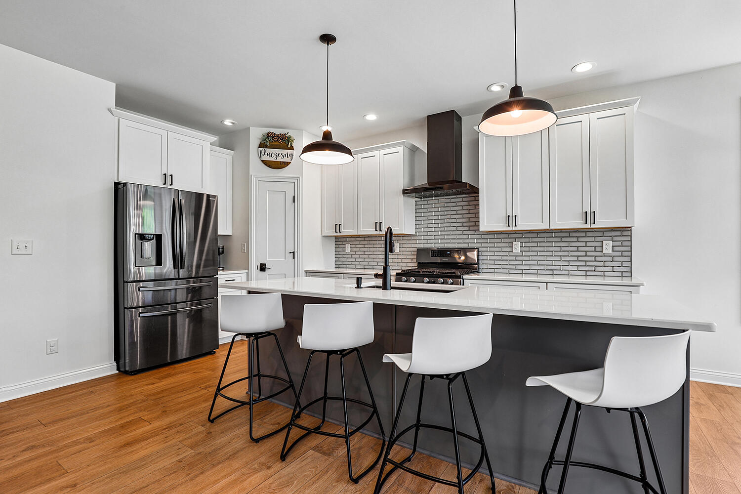17152 High Point Court Lowell, IN 46356 - Photo 12 of 54 a kitchen with stainless steel appliances kitchen island a refrigerator a stove a sink and chairs