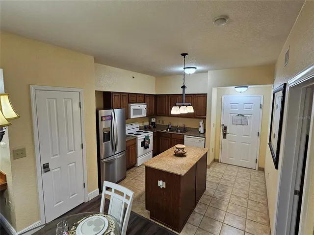 a kitchen with a refrigerator sink and stove