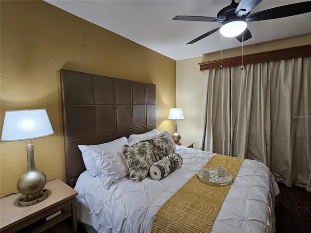 a bedroom with a bed and a lamp