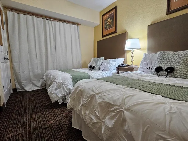 a bedroom with bed and a night stand