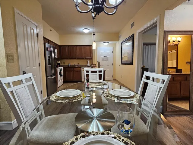 a kitchen with a table chairs stove and refrigerator
