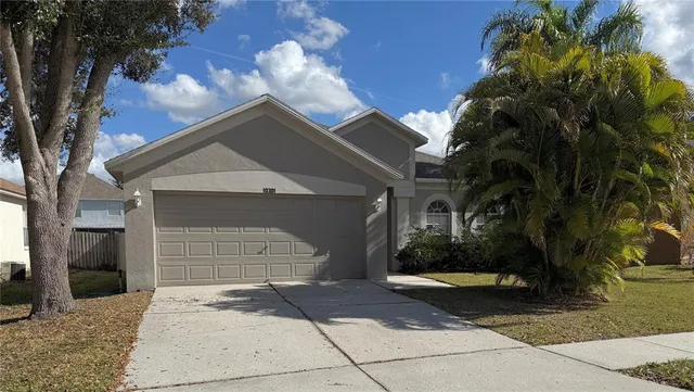 a front view of a house with a yard and garage