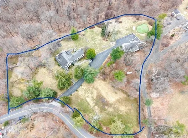 a view of a wooden floor with a vase of flowers on it