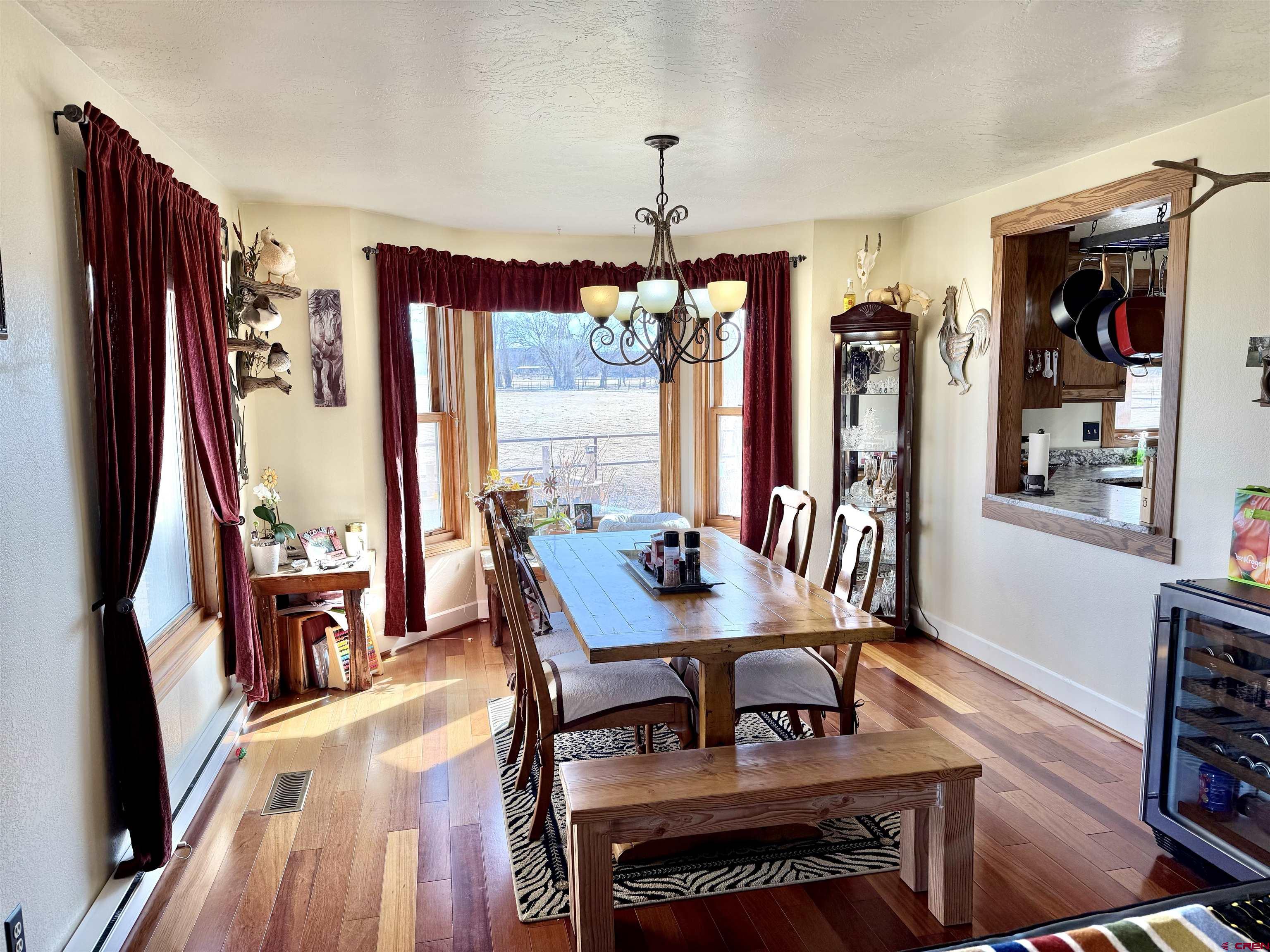 66176 Riverside Road Montrose, CO 81403 - Photo 16 of 45 a view of a dining room with furniture window and wooden floor