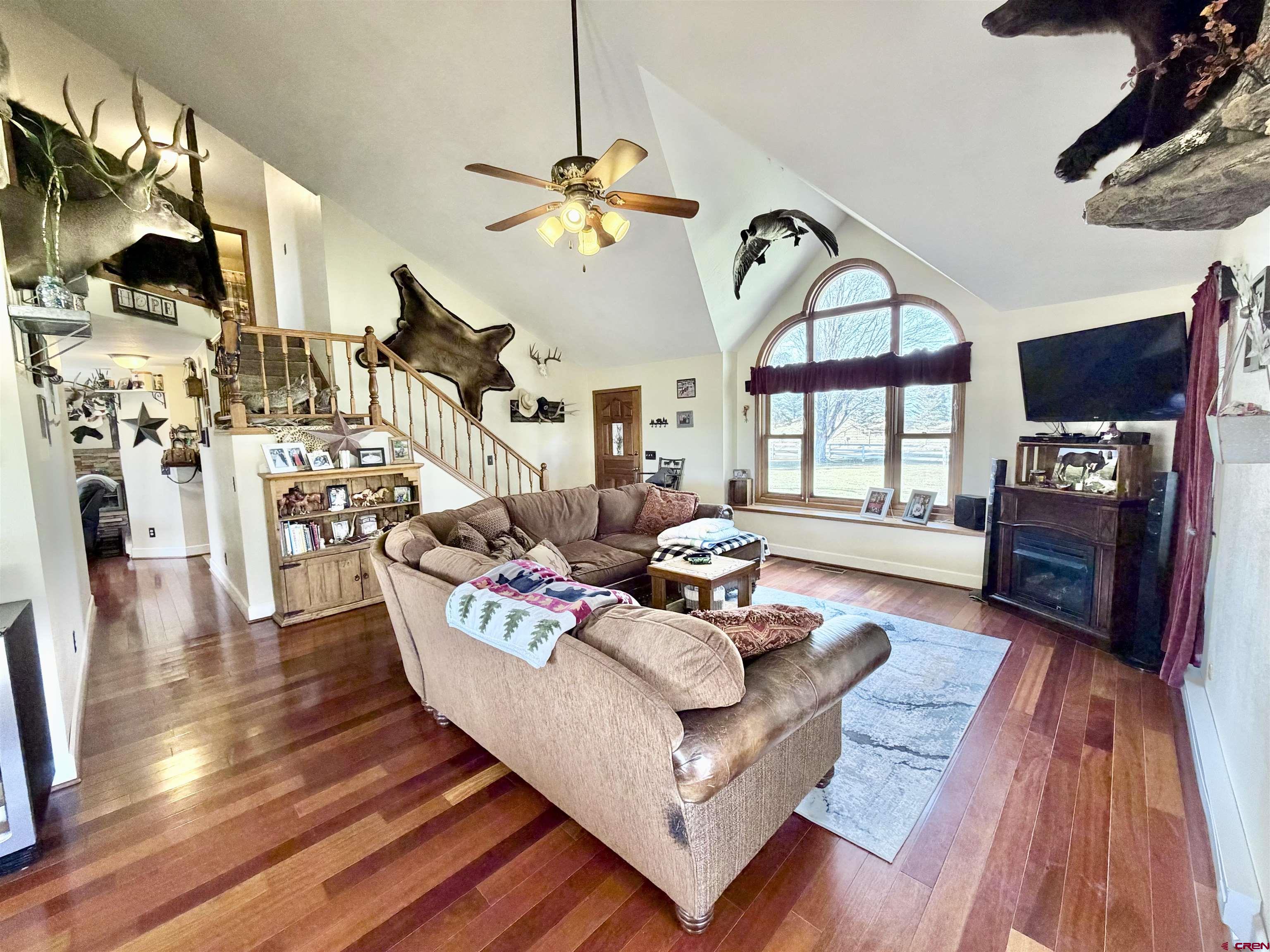 66176 Riverside Road Montrose, CO 81403 - Photo 17 of 45 a living room with fireplace furniture and a flat screen tv