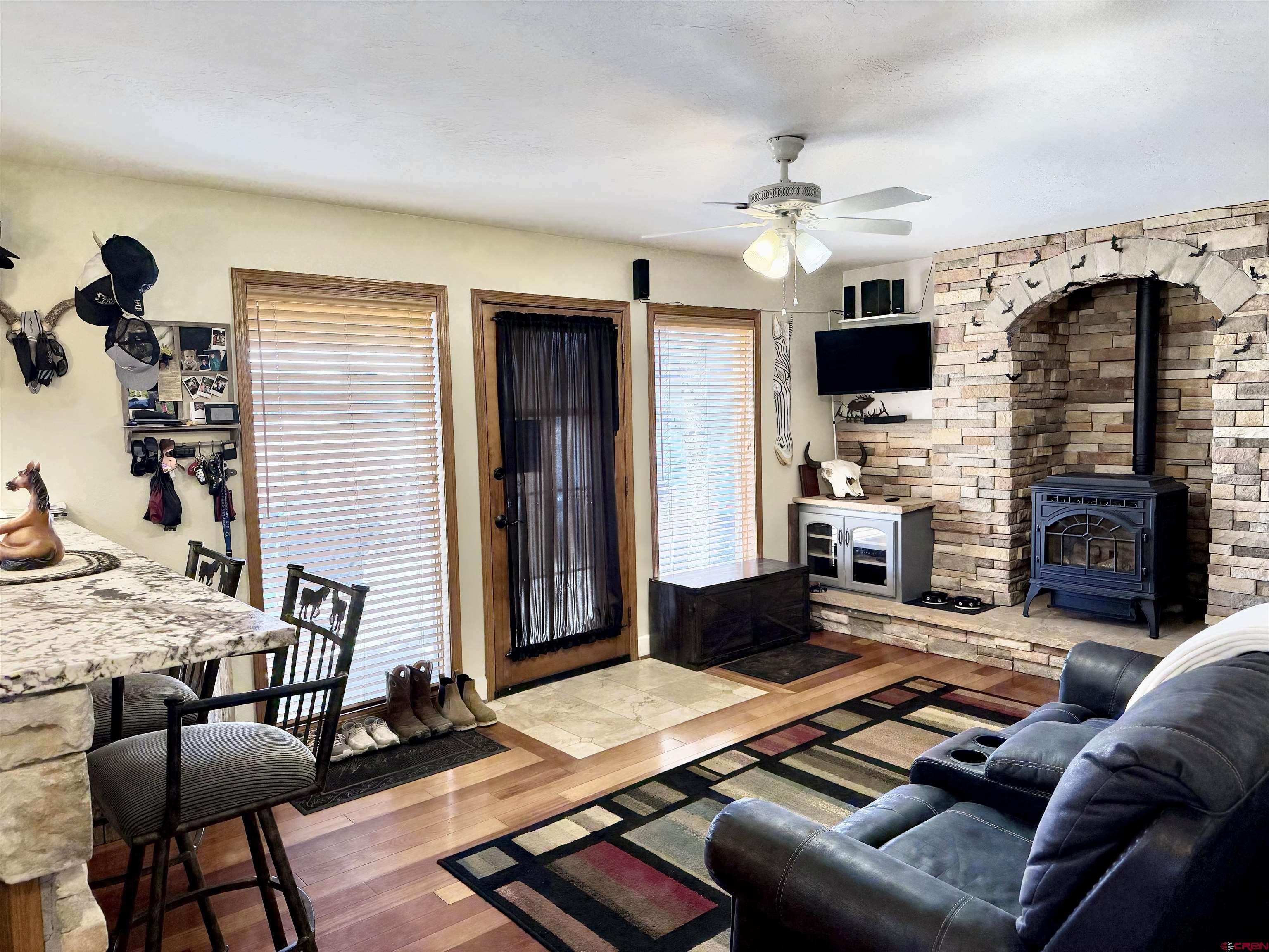 66176 Riverside Road Montrose, CO 81403 - Photo 18 of 45 a living room with furniture a flat screen tv and a fireplace