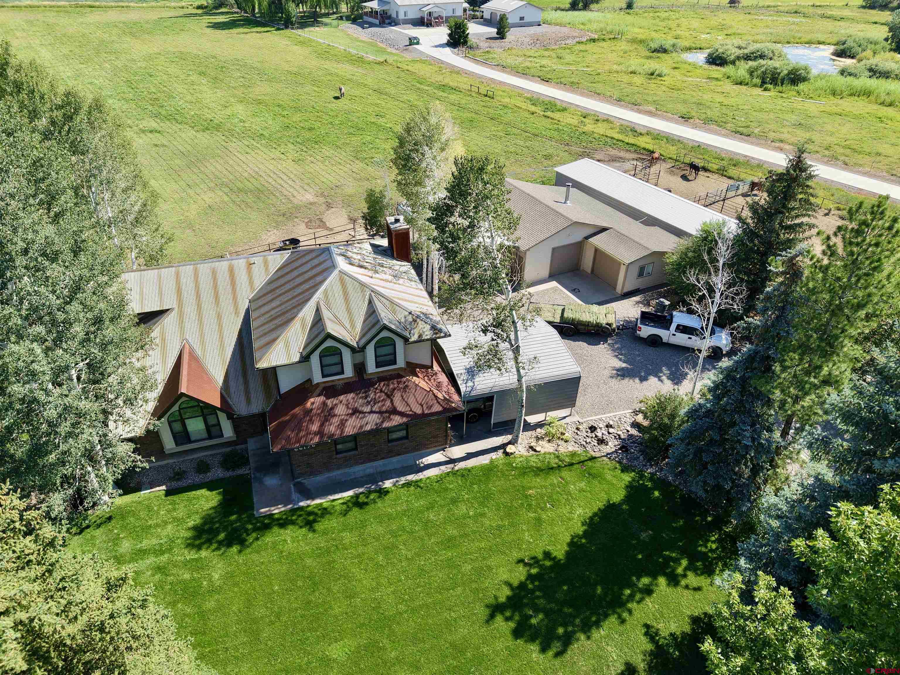 66176 Riverside Road Montrose, CO 81403 - Photo 2 of 45 an aerial view of a house with garden space and street view