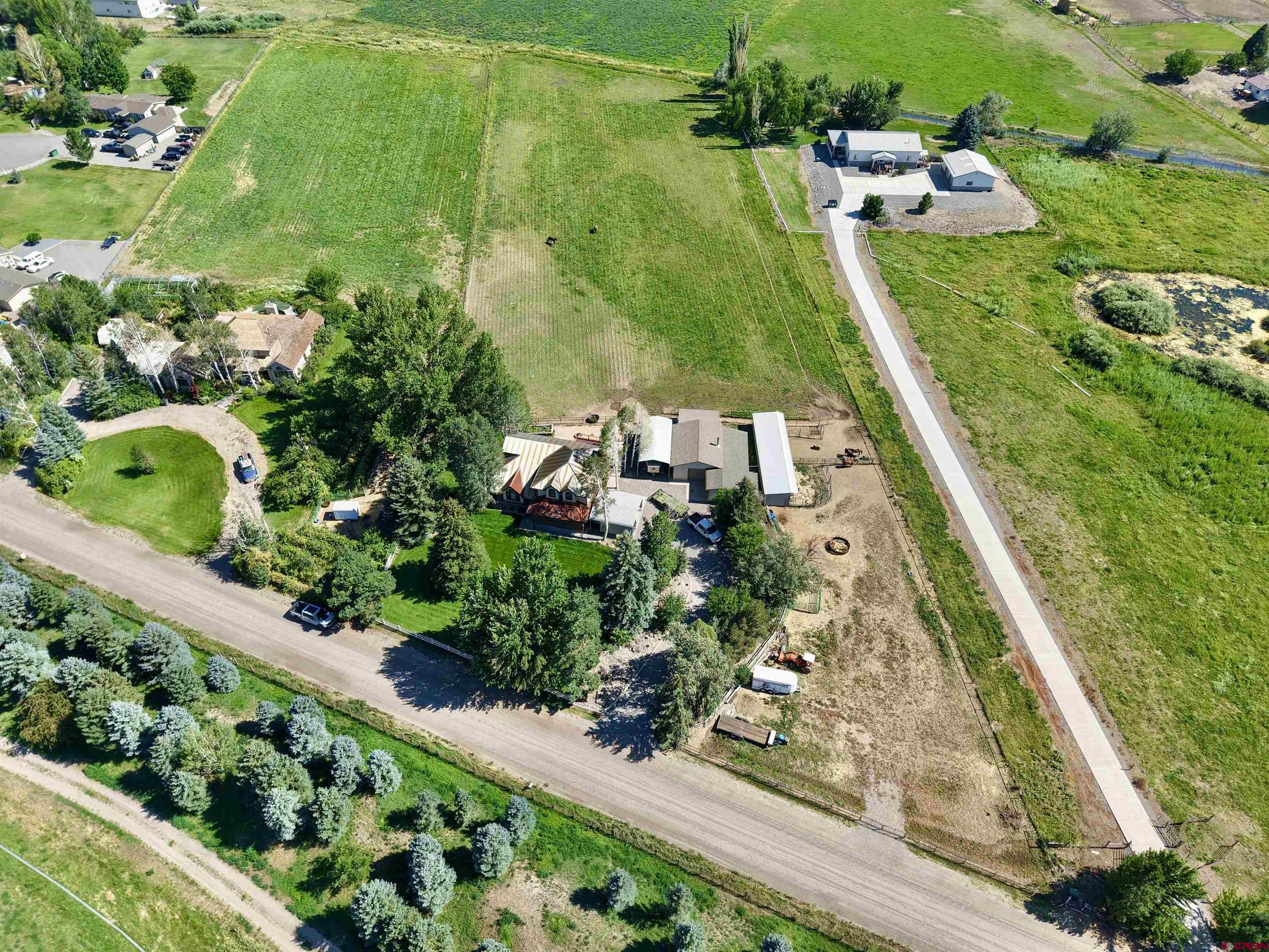 66176 Riverside Road Montrose, CO 81403 - Photo 41 of 45 an aerial view of a residential houses with outdoor space and street view