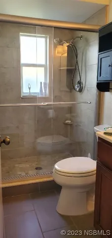 a white house sitting next to a white wall